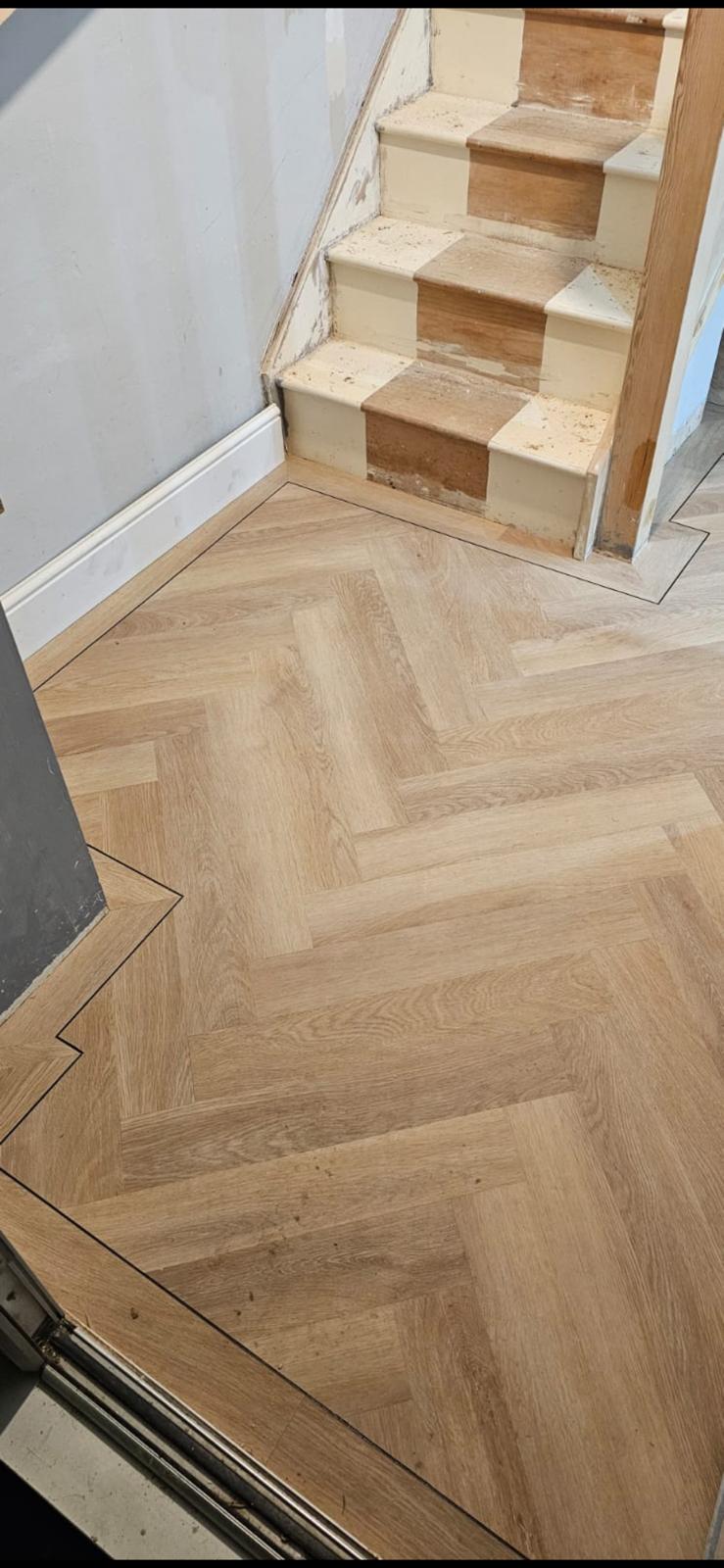 Herringbone luxury vinyl tile flooring installed in a Norfolk hallway by Compass Flooring