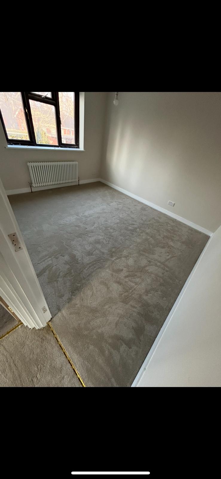 Soft grey carpet professionally fitted in a bedroom by Compass Flooring Norfolk
