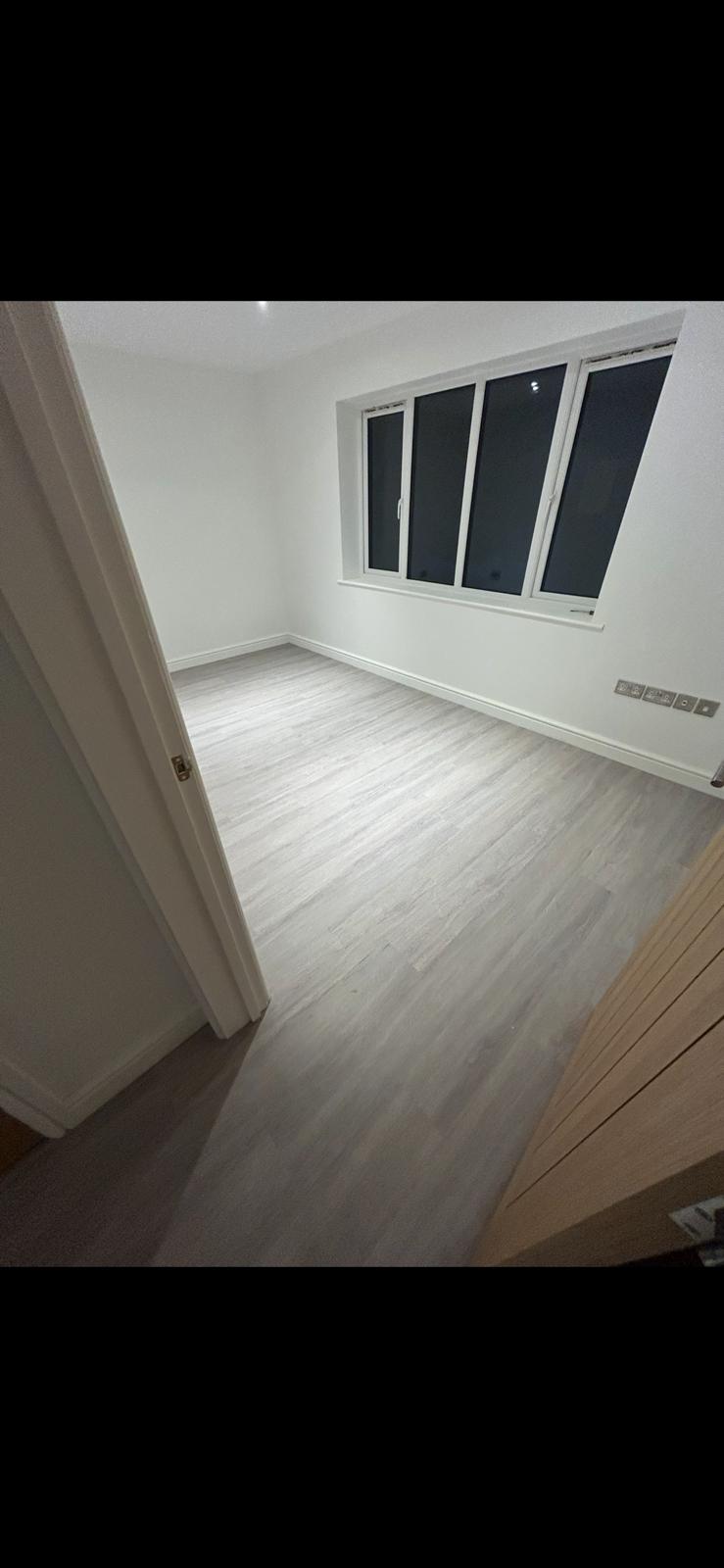 Light grey vinyl sheet flooring installed in a Norfolk room by Compass Flooring